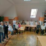W szkolnej sali zgromadzili się uczniowie biorący udział w szkolnym konkursie „Pięknego Czytania” i słuchają pani nauczycielki, która tłumaczy im zasady rywalizacji.