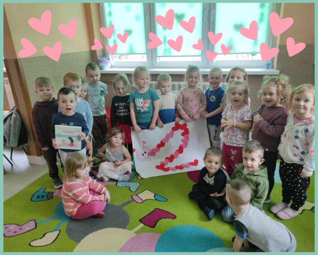 na zdjęciu widać dzieci z najmłodszej grupy przedszkolnej, prezentują zbiorową pracę plastyczną