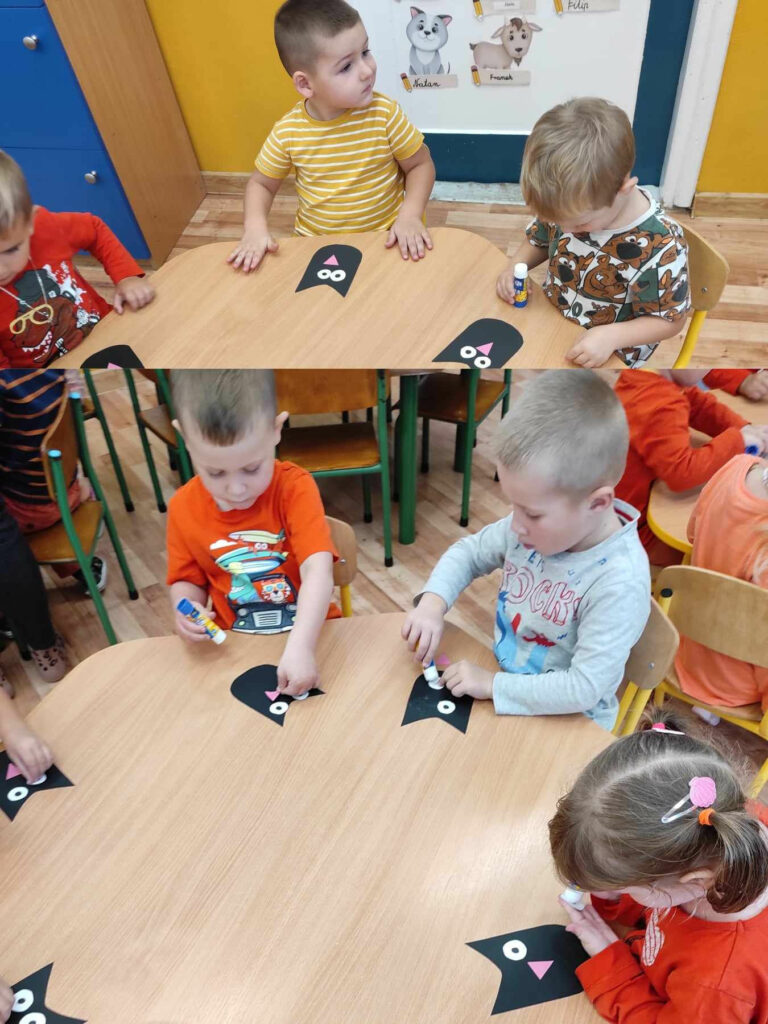 na zdjęciu widać dzieci, siedzą przy stoliku, wykonują pracę plastyczną