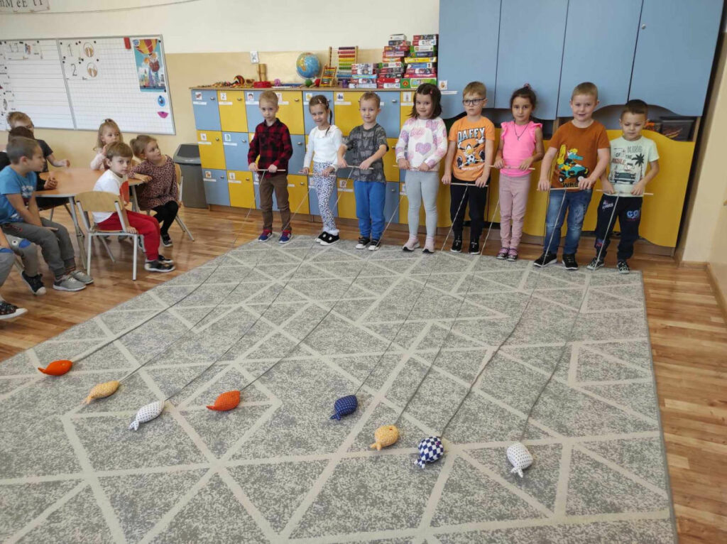 na zdjęciu widać salę przedszkolną, dzieci bawią się w łowienie rybek