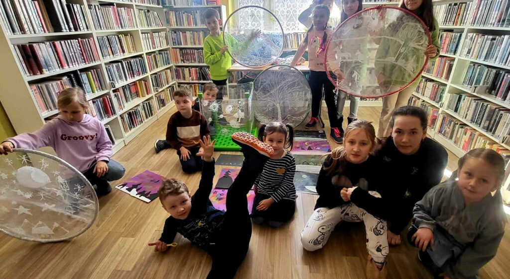 na zdjęciu widać dzieci w sali bibliotecznej