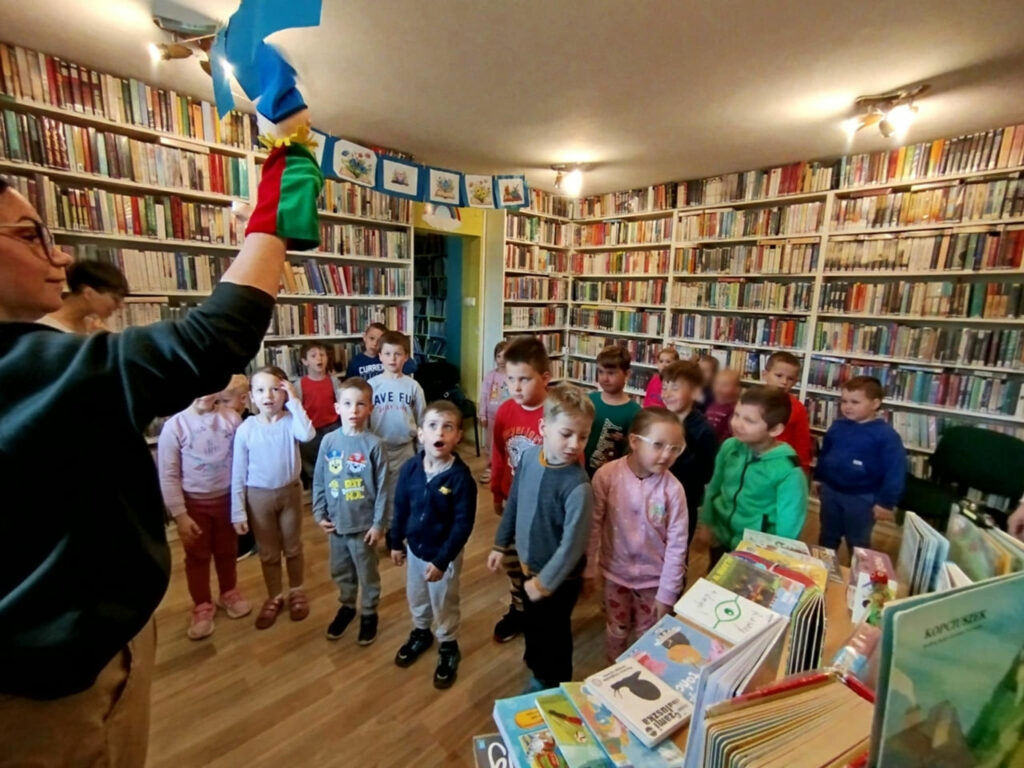 na zdjęciu widać dzieci w sali bibliotecznej