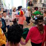 na zdjęciu widać tańczące dzieci w sali bibliotecznej