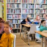 na zdjęciu widać dzieci w sali bibliotecznej