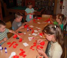 dzieci sklejają ze sobą wcześniej przygotowane płatki swoich kwiatów